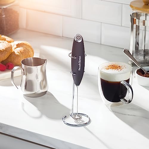Peach Street milk frother on a kitchen counter beside a cappuccino